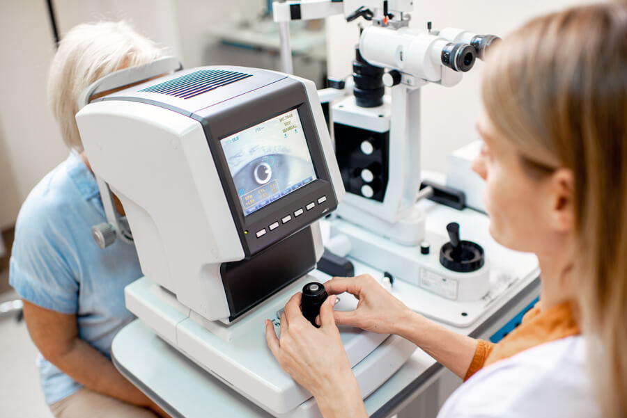 Eye doctor checking for diabetic retinopathy in a woman