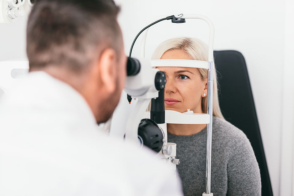 Retina care specialist examining a patient's eyes 