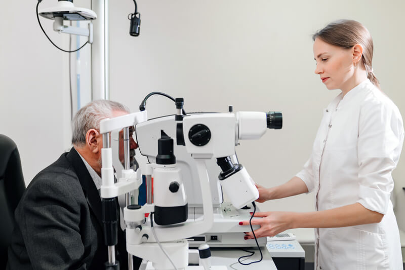Doctor at retina eye clinic in Zachary examining patient