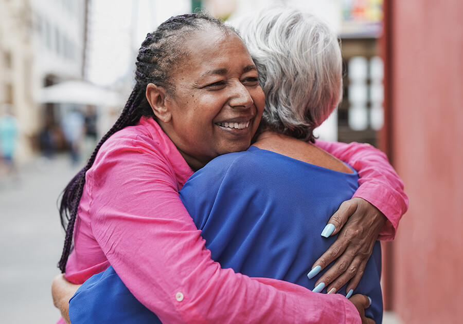 Elderly women hugging each other happy after retina specialist in Covington