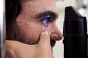 man visiting eye doctor to ask about retinal heath