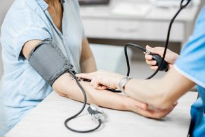 woman getting blood pressure checked to understand how to improve retina health